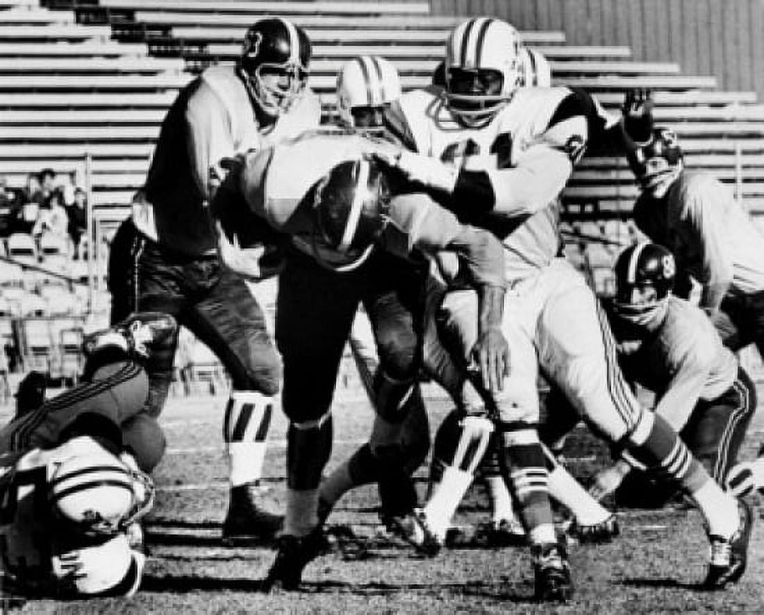 American football players playing football on field Canvas Art - (24 x 36)