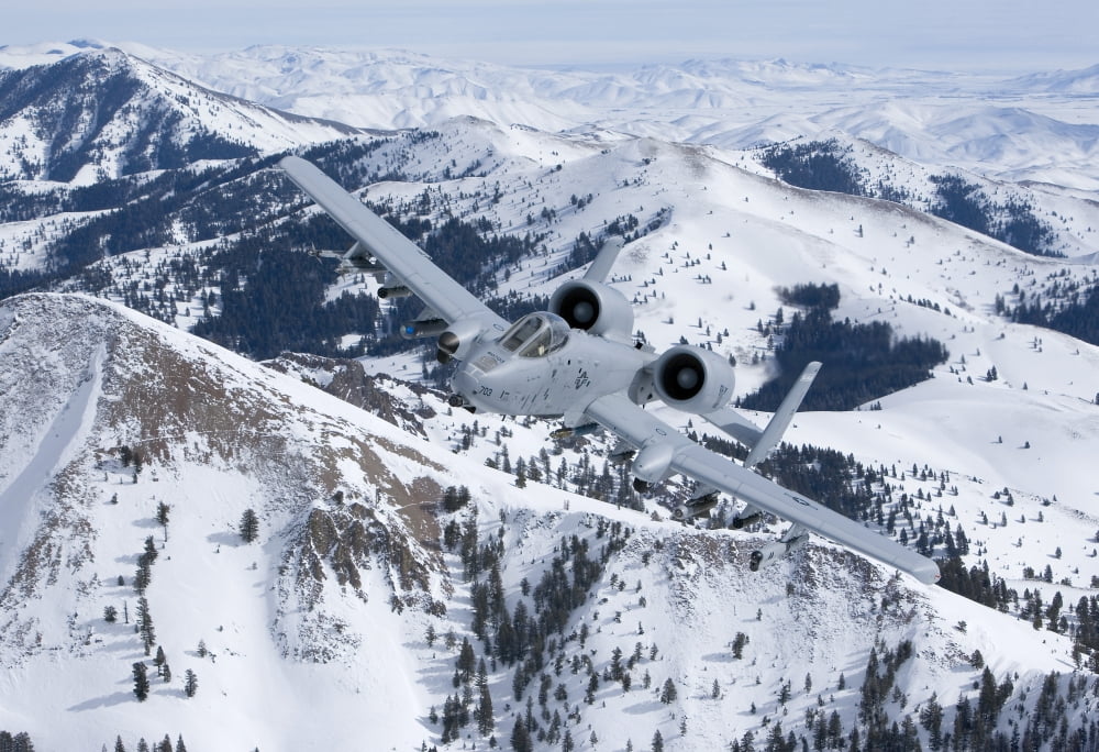 An A-10C Thunderbolt flies over the snowy Idaho countryside Canvas Art - HIGH-G ProductionsStocktrek Images (35 x 24)