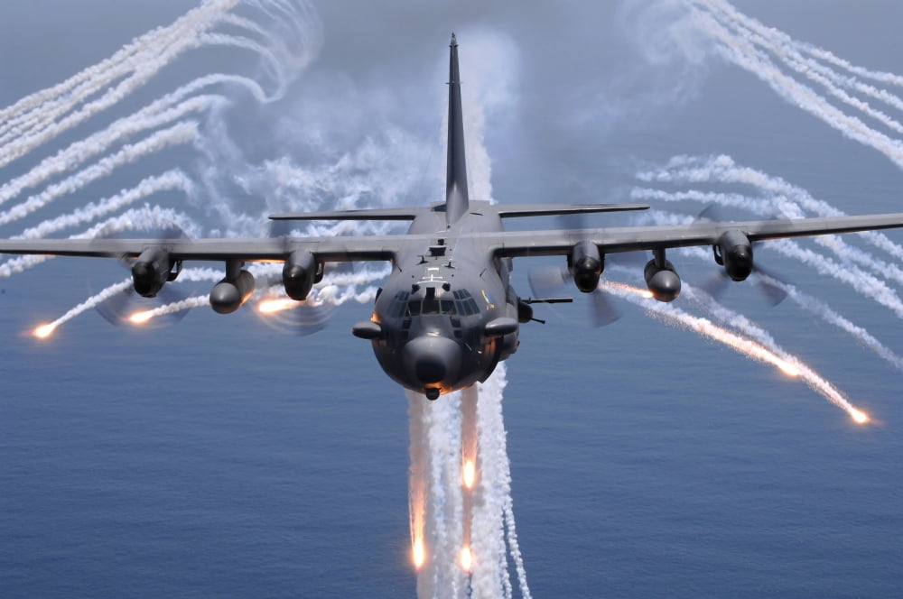 An AC-130H gunship aircraft jettisons flares as an infrared countermeasure Canvas Art - Stocktrek Images (34 x 23)
