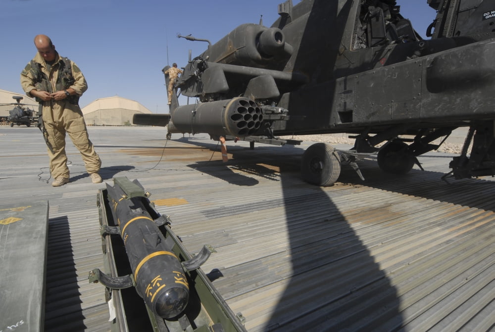 An AGM-114 Hellfire missile is ready to be loaded onto an AH-64 Apache Canvas Art - Andrew ChittockStocktrek Images (17 x 12)