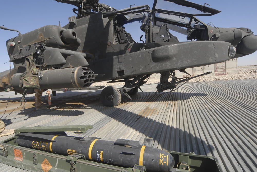 An AGM-114 Hellfire missile is ready to be loaded onto an AH-64 Apache Canvas Art - Andrew ChittockStocktrek Images (34 x 23)