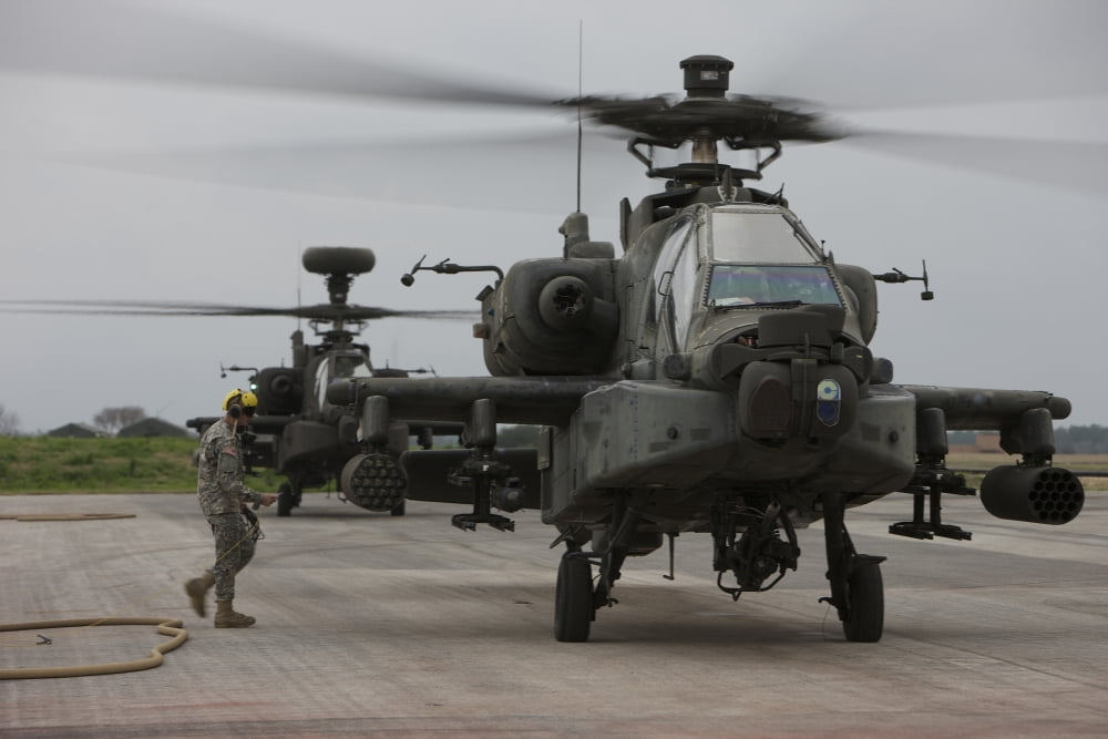 An AH-64 Apache helicopter undergoes refueling Canvas Art - Terry MooreStocktrek Images (18 x 12)