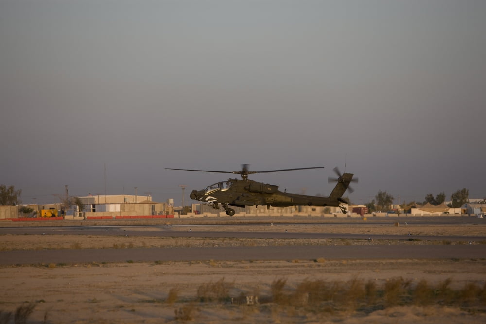 An AH-64D Apache Longbow Block III attack helicopter hovers above the runway Canvas Art - Terry MooreStocktrek Images (35 x 23)