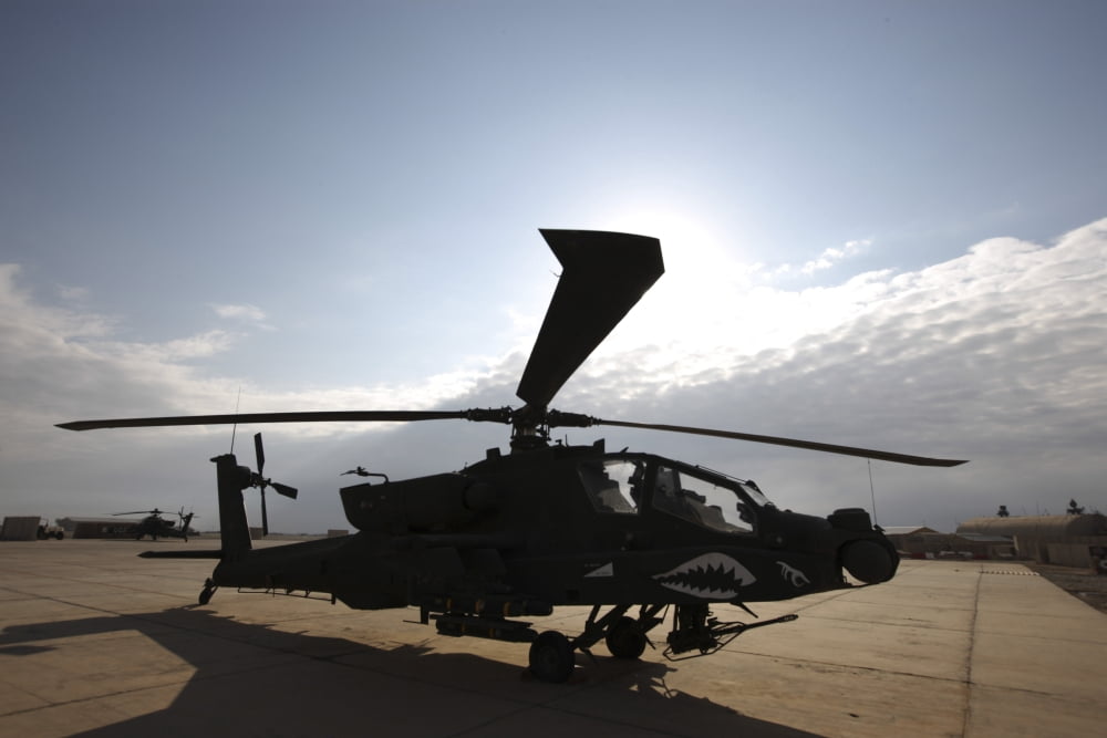 An AH-64D Apache Longbow Block III on the flight line at Camp Speicher Canvas Art - Terry MooreStocktrek Images (34 x 23)