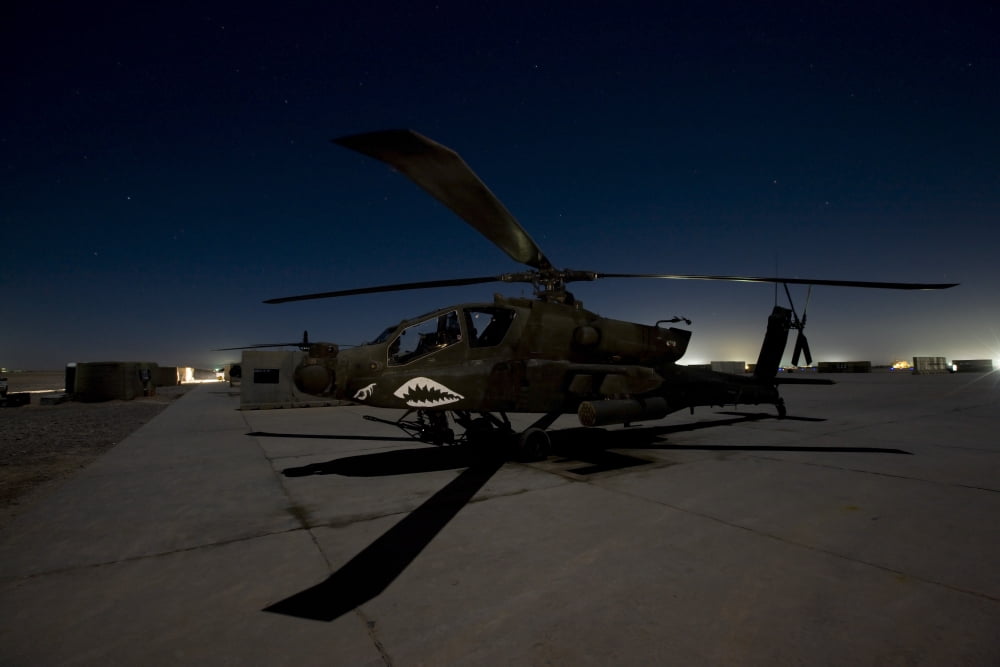An AH-64D Apache Longbow Block III on the flight line at night Canvas Art - Terry MooreStocktrek Images (34 x 23)