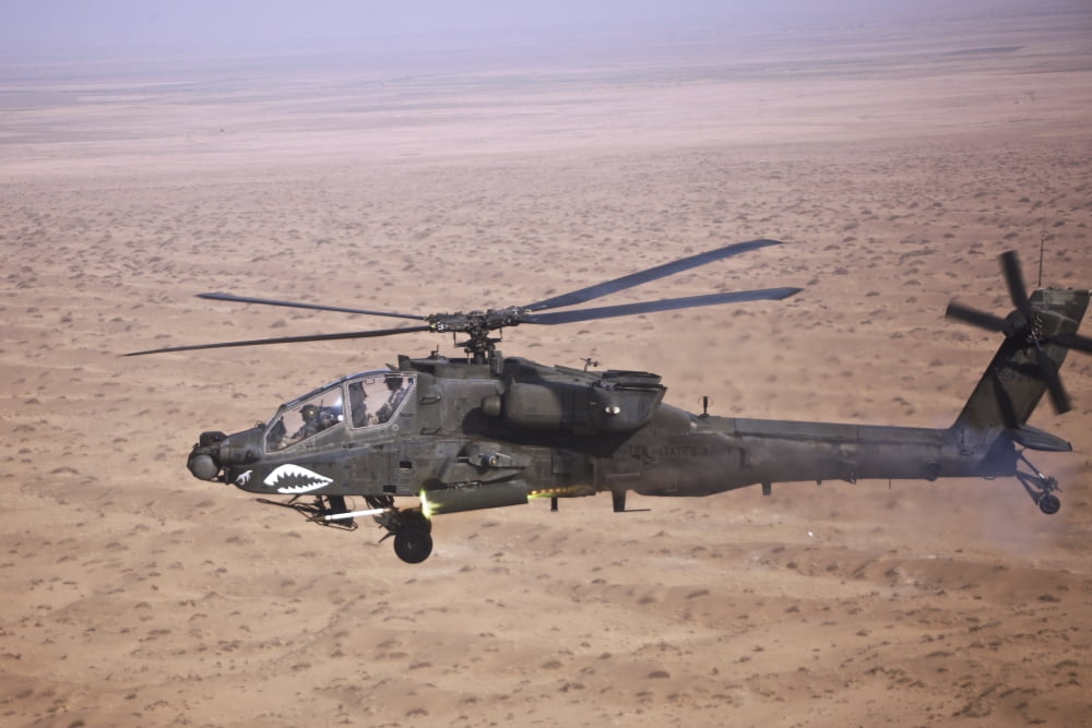 An AH-64D Apache Longbow fires a hydra rocket over Iraq Canvas Art - Terry MooreStocktrek Images (35 x 23)