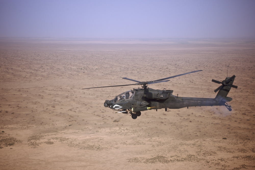 An AH-64D Apache Longbow fires a hydra rocket over Iraq Canvas Art - Terry MooreStocktrek Images (35 x 23)