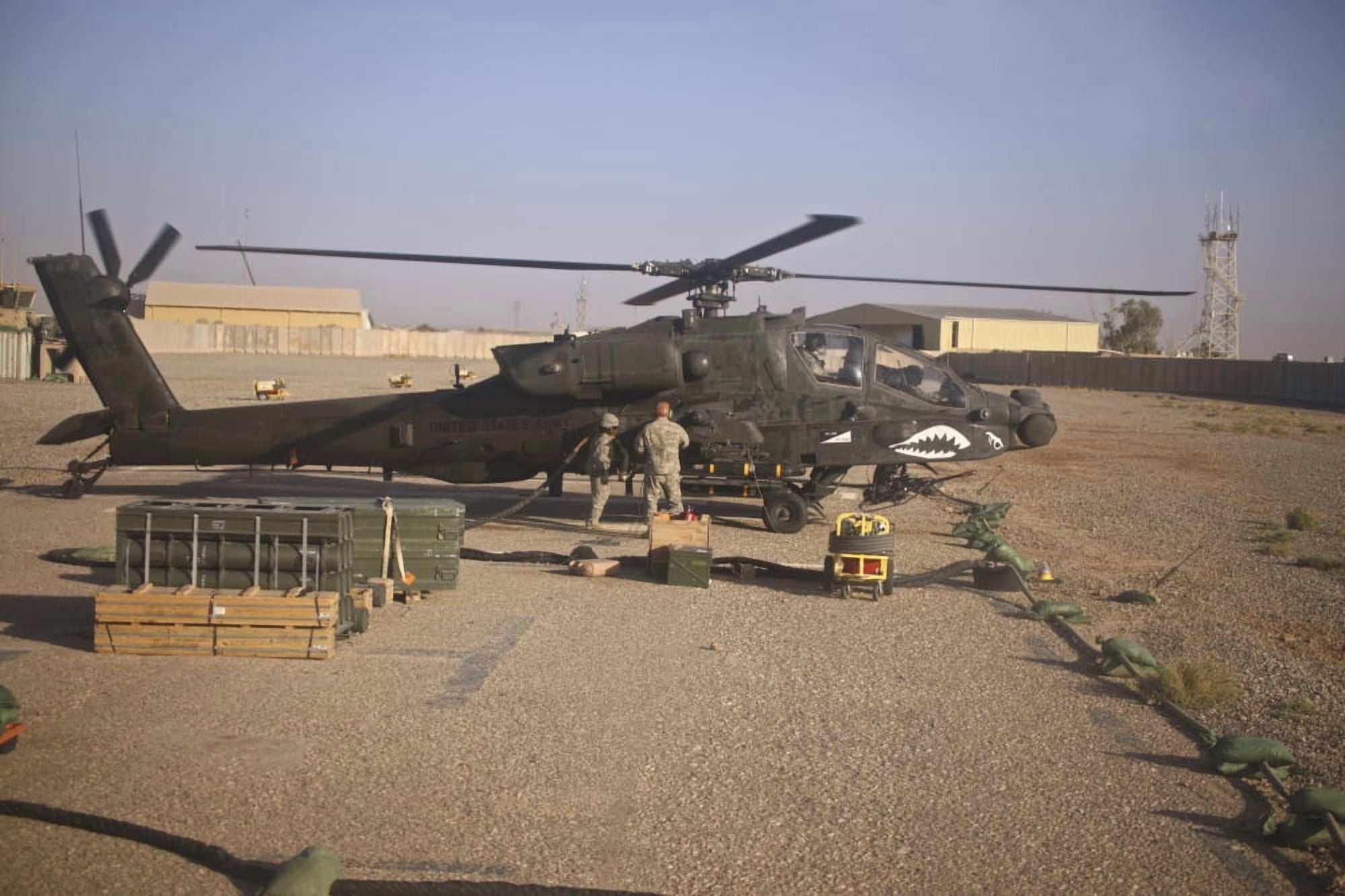 An AH-64D Apache Longbow receives fuel at a military base in Iraq Canvas Art - Terry MooreStocktrek Images (35 x 23)