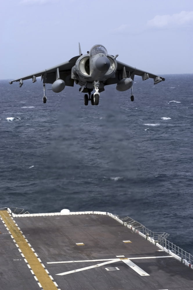 An AV-8B Harrier II prepares to land on the flight deck of USS Nassau Canvas Art - Stocktrek Images (23 x 35)