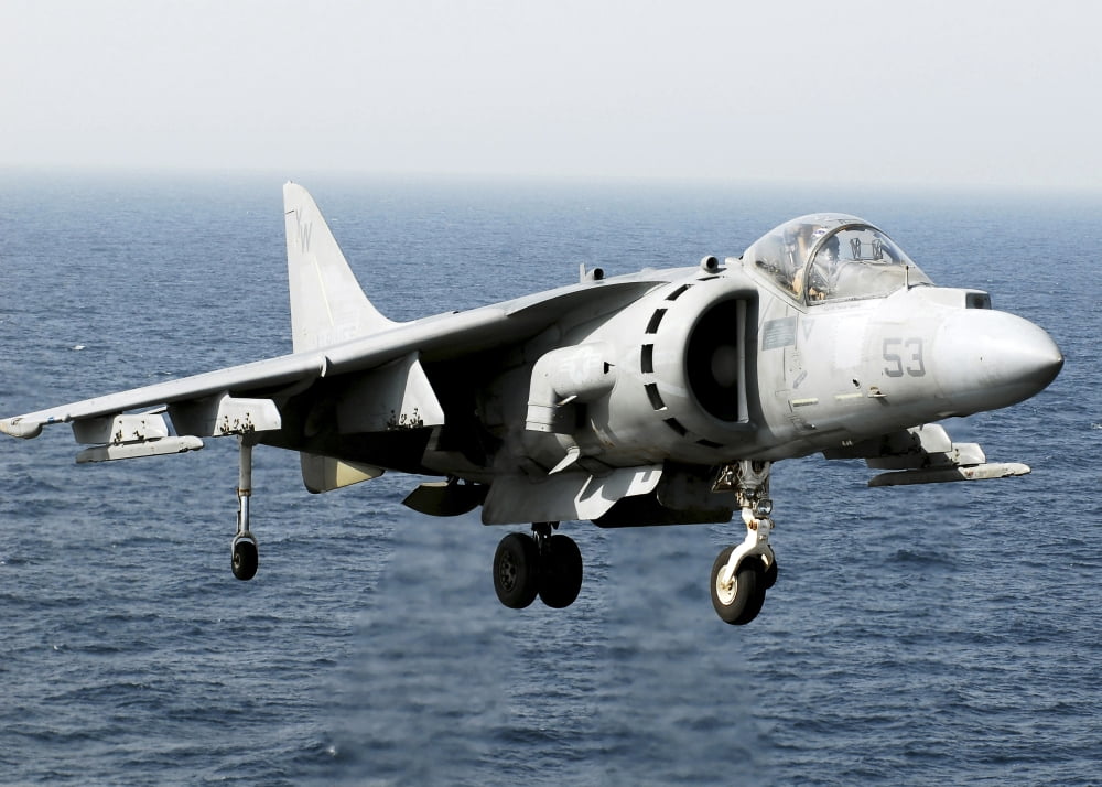 An AV-8B Harrier hovers over the flight deck of USS peleliu Canvas Art - Stocktrek Images (34 x 24)