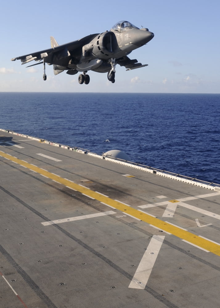 An AV-8B Harrier jet prepares to land on the flight deck of USS Essex Canvas Art - Stocktrek Images (24 x 34)