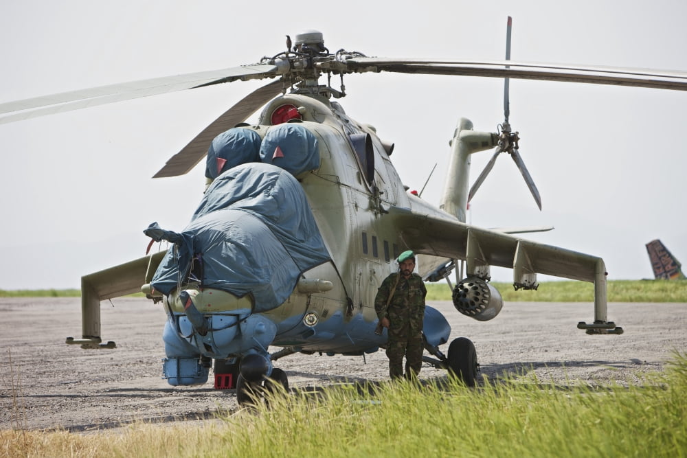 An Afghan Army soldier guards a Mi-35 attack helicopter Canvas Art - Terry MooreStocktrek Images (18 x 12)