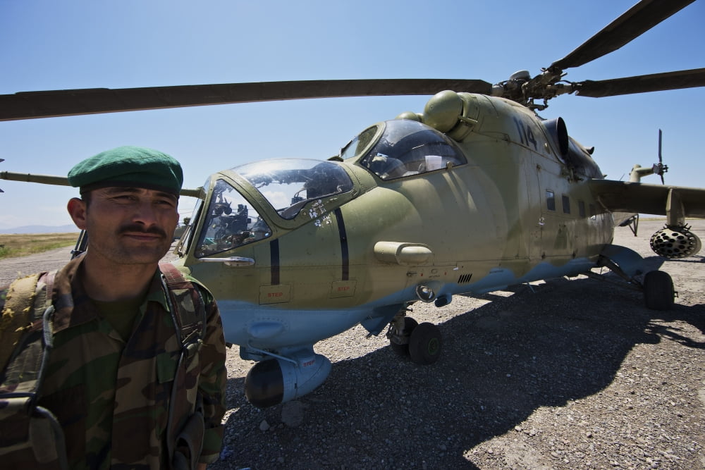 An Afghan Army soldier guards an Mi-35 attack helicopter Canvas Art - Terry MooreStocktrek Images (35 x 24)