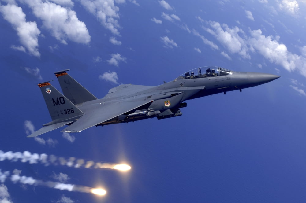 An Air Force F-15E Strike Eagle fires flares during an aerial training dog fight off the coast of Guam Canvas Art - Stocktrek Images (35 x 23)