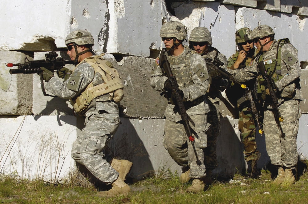 An Air Force joint terminal attack controller integrates with doldiers to receive an intelligence briefing Canvas Art - Stocktrek Images (34 x 23)