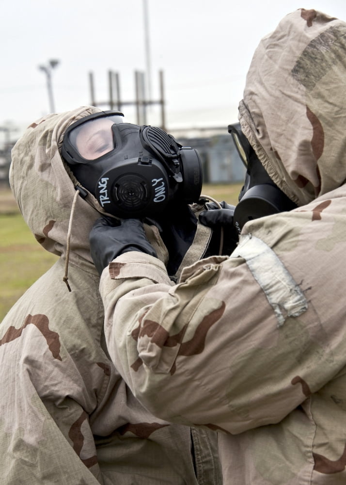 An Airman assists his wingman during an operational readiness exercise Canvas Art - Stocktrek Images (24 x 33)