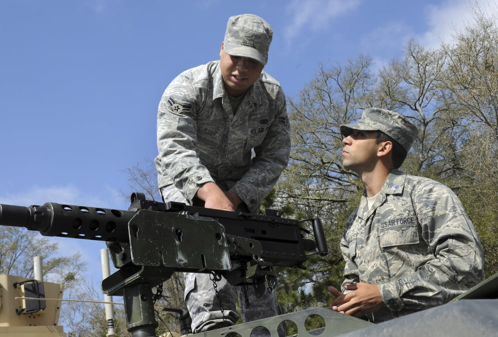 An Airman instructs a Cadet on how to use the M-2 heavy machine gun Canvas Art - Stocktrek Images (34 x 23)