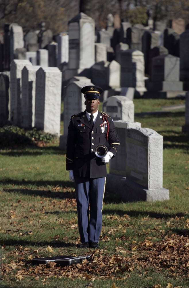 An Army soldier stands in the Cypress Hills National Cemetery waiting to play taps Canvas Art - Stocktrek Images (23 x 34)