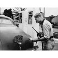 thumbnail image 1 of An Automobile Service Station Attendant Measures Out Gasoline In Accordance With The World War Ii Gasoline Rationing., 1 of 1