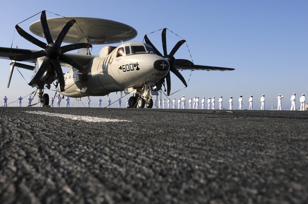 An E-2C Hawkeye sits on the flight deck of USS Abraham Lincoln while sailors man the rails Canvas Art - Stocktrek Images (35 x 23)