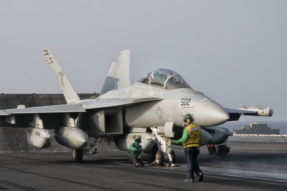 An EA-18G Growler is guided into catapult aboard USS George HW Bush Canvas Art - Giovanni CollaStocktrek Images (35 x 23)