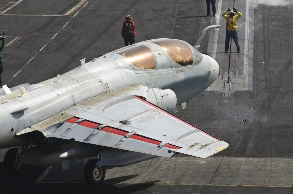 An EA-6B Prowler is guided onto a catapult aboard USS Harry S Truman Canvas Art - Giovanni CollaStocktrek Images (18 x 12)