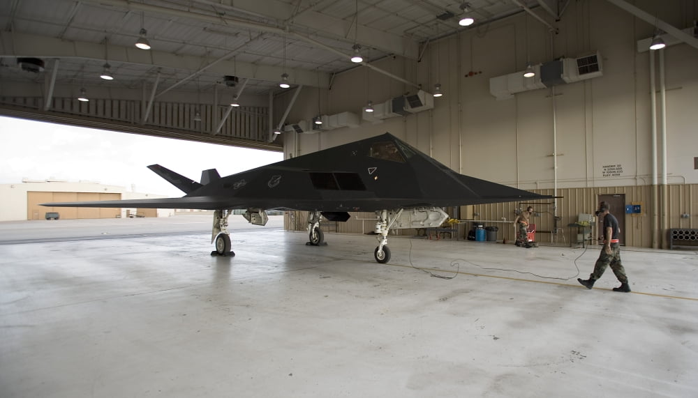 An F-117 Nighthawk parked in the hangar bay Canvas Art - HIGH-G ProductionsStocktrek Images (19 x 11)