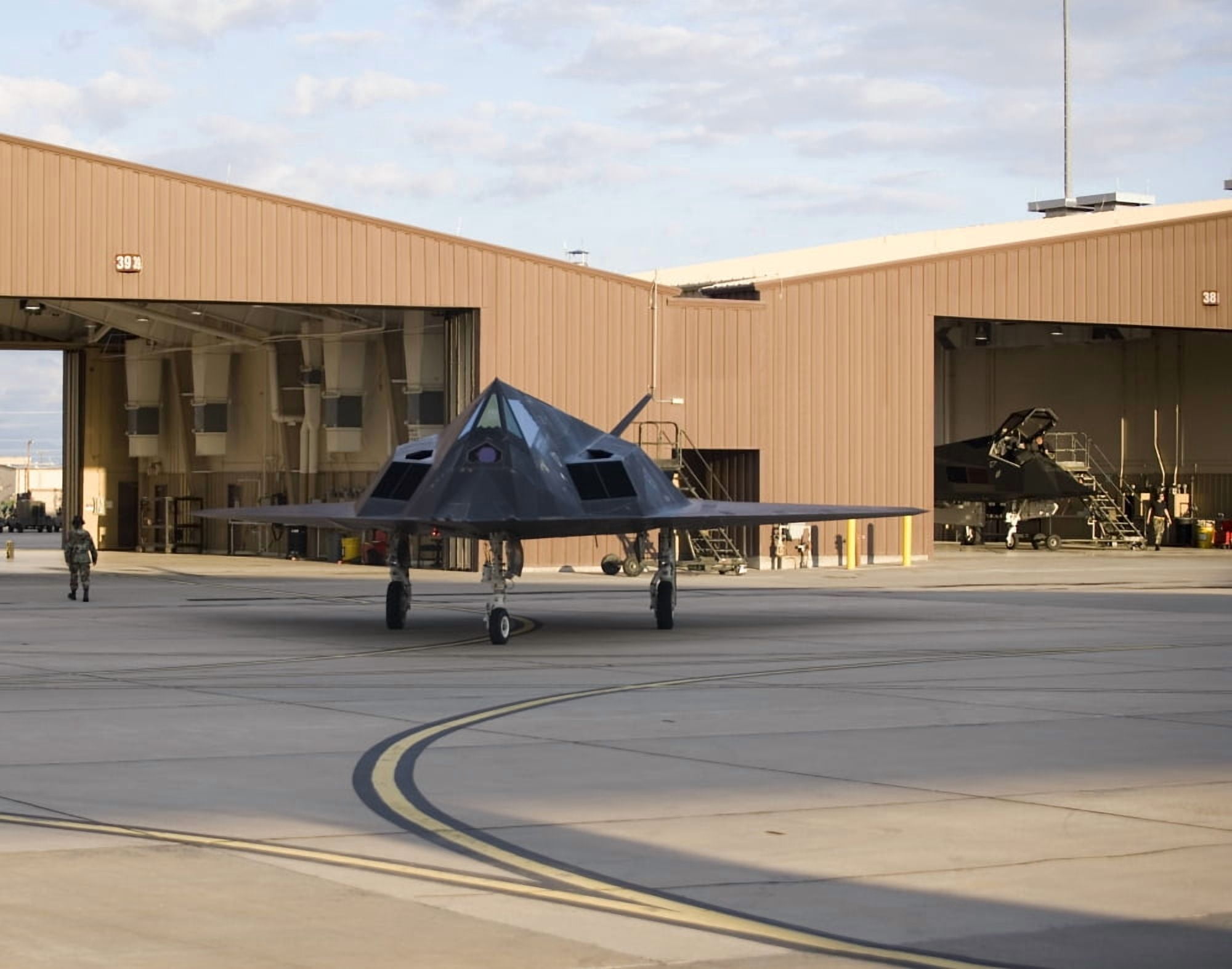 An F-117 Nighthawk taxis out of its hangar Canvas Art - HIGH-G ProductionsStocktrek Images (32 x 25)
