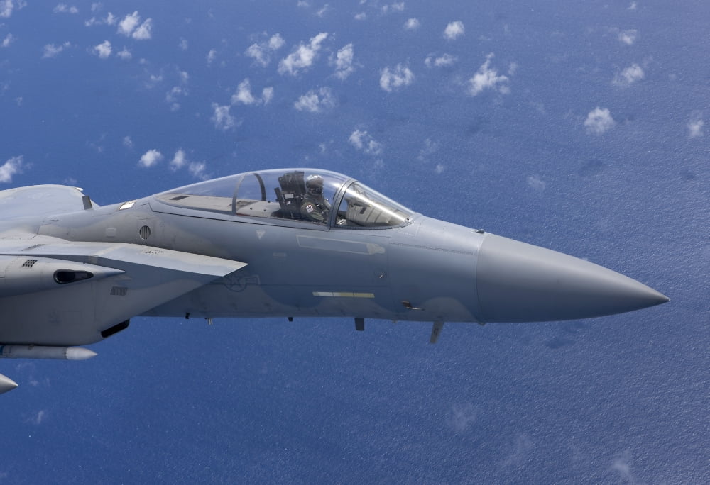 An F-15 Eagle flies over the Pacific Ocean during a training mission Canvas Art - HIGH-G ProductionsStocktrek Images (35 x 24)