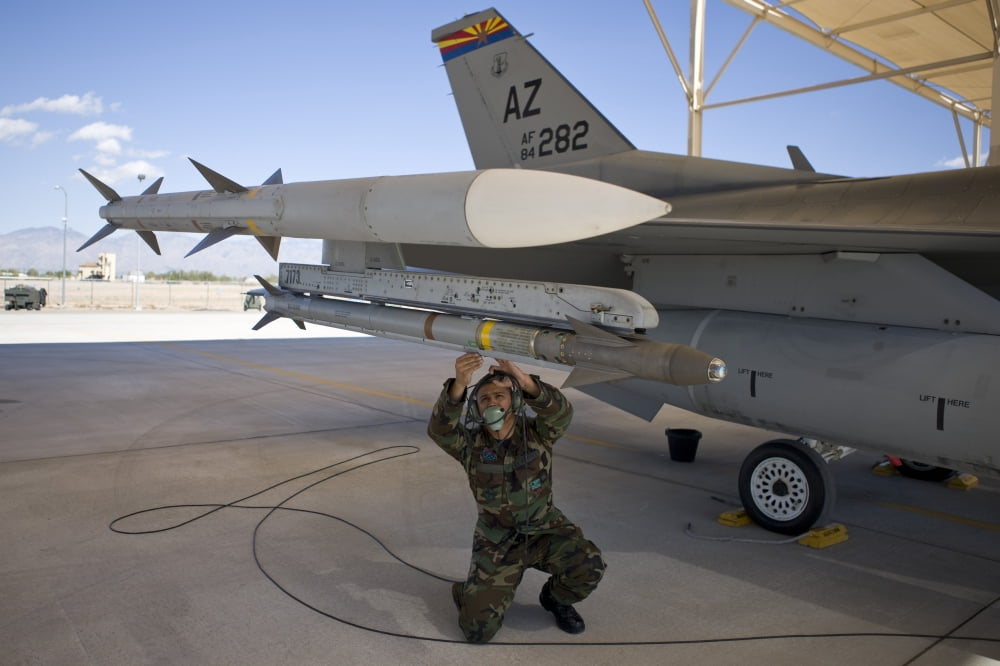 An F-16 crew chief conducts preflight checks on an AIM-9X missile Canvas Art - HIGH-G ProductionsStocktrek Images (18 x 12)