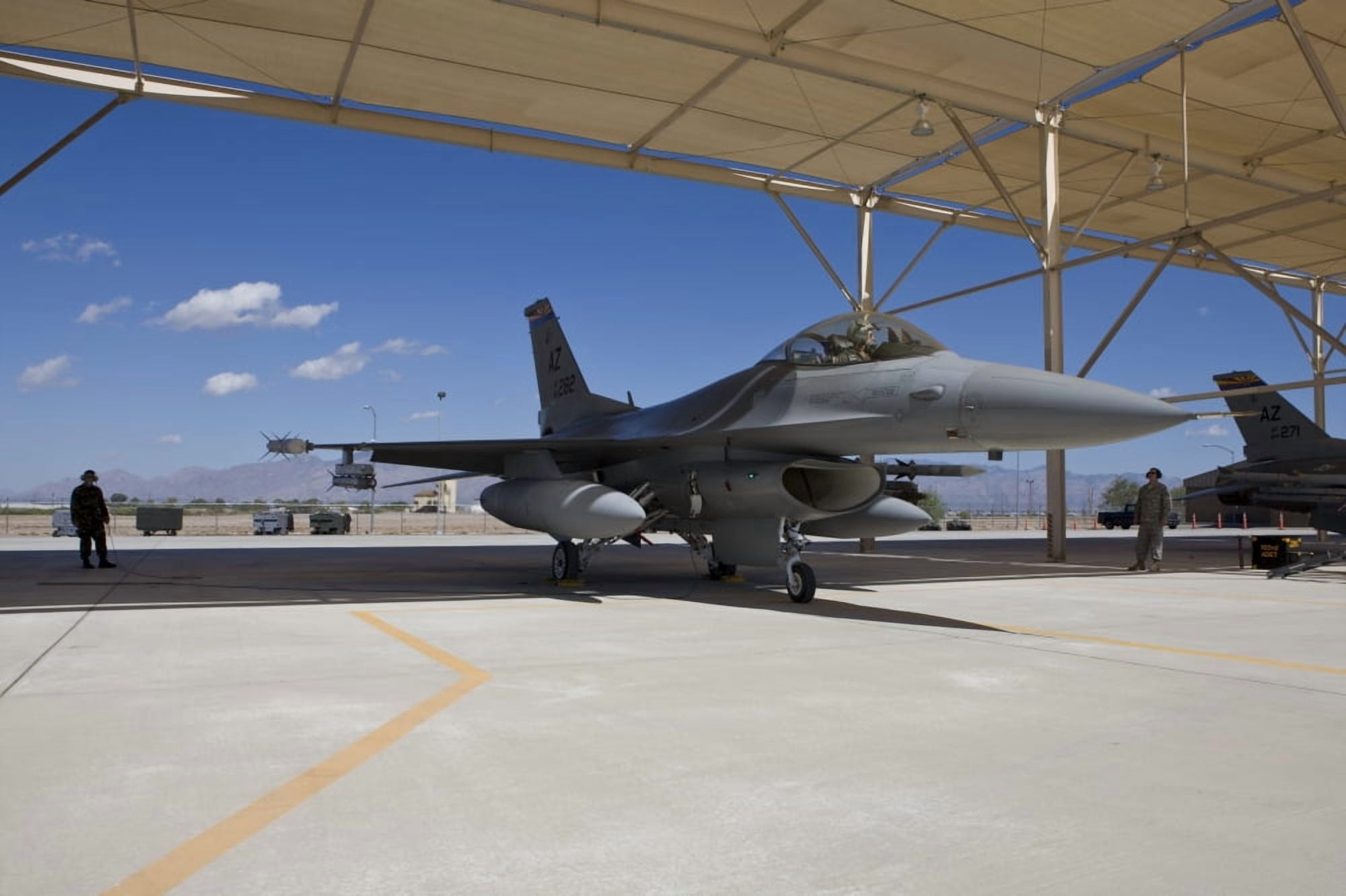 An F-16 pilot onducts preflight checks at Davis-Monthan Air Force Base Arizona Canvas Art - HIGH-G ProductionsStocktrek Images (36 x 24)