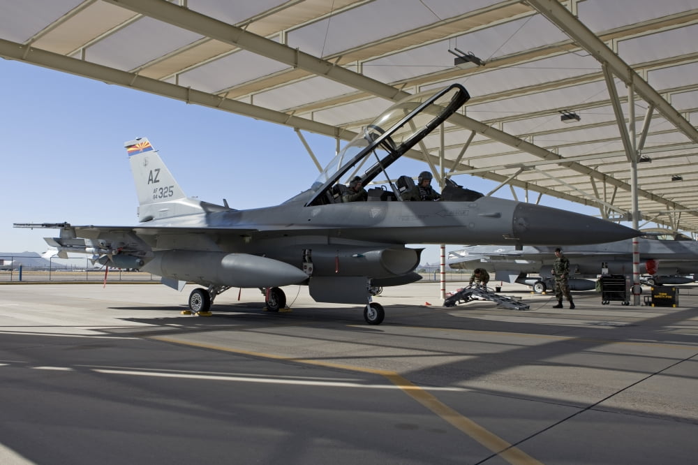 An F-16 pilot onducts preflight checks on his aircraft Canvas Art - HIGH-G ProductionsStocktrek Images (18 x 12)