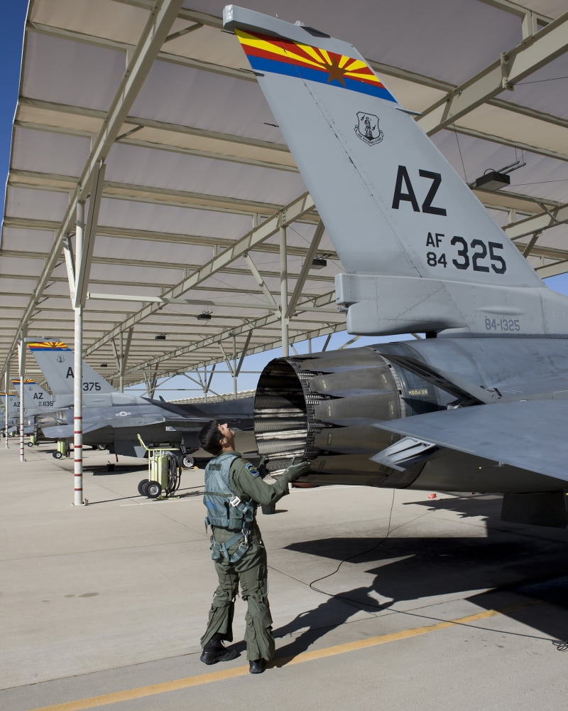 An F-16 pilot onducts preflight checks on his aircraft Canvas Art - HIGH-G ProductionsStocktrek Images (26 x 32)