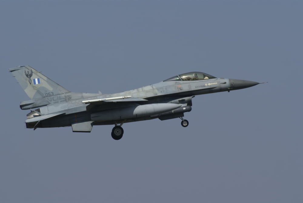 An F-16C Fighting Falcon of the Hellenic Air Force over Florennes Belgium Canvas Art - Ramon Van OpdorpStocktrek Images (35 x 23)