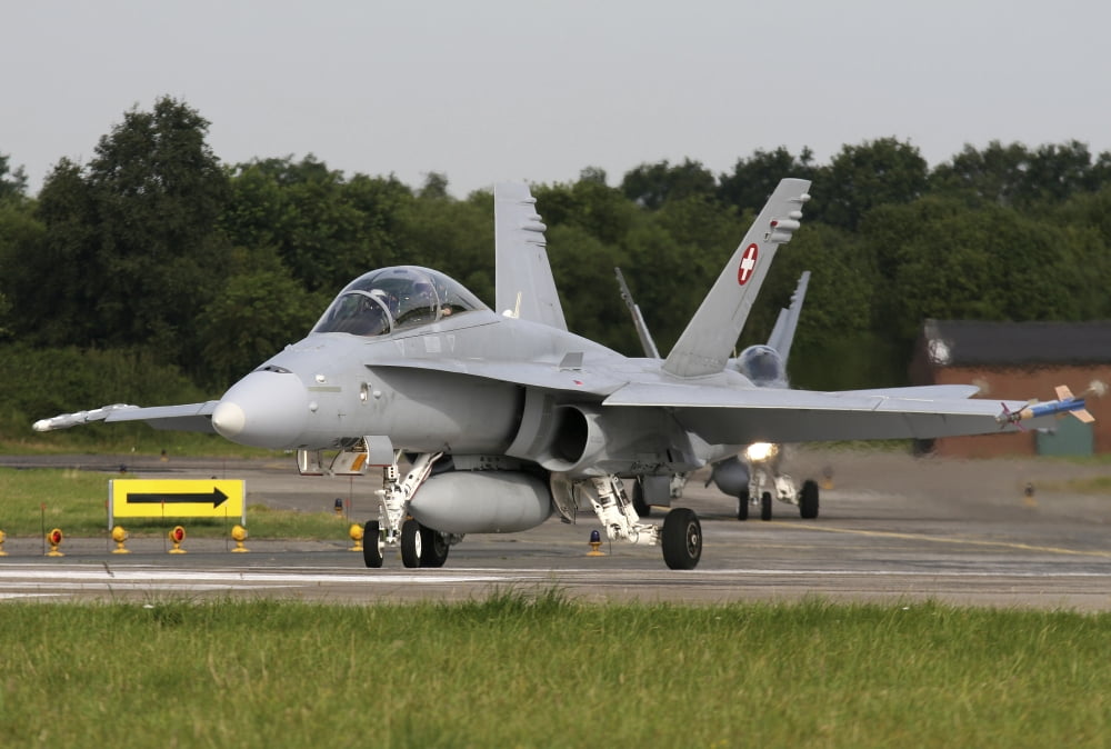 An F-18C Hornet of the Swiss Air Force taxiing for departure Canvas Art - Timm ZiegenthalerStocktrek Images (18 x 12)
