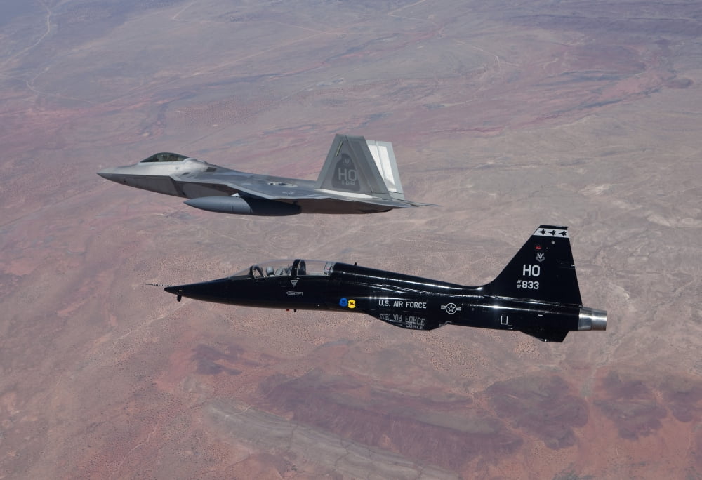 An F-22 Raptor and a T-38 Talon fly in formation over New Mexico Canvas Art - HIGH-G ProductionsStocktrek Images (35 x 24)
