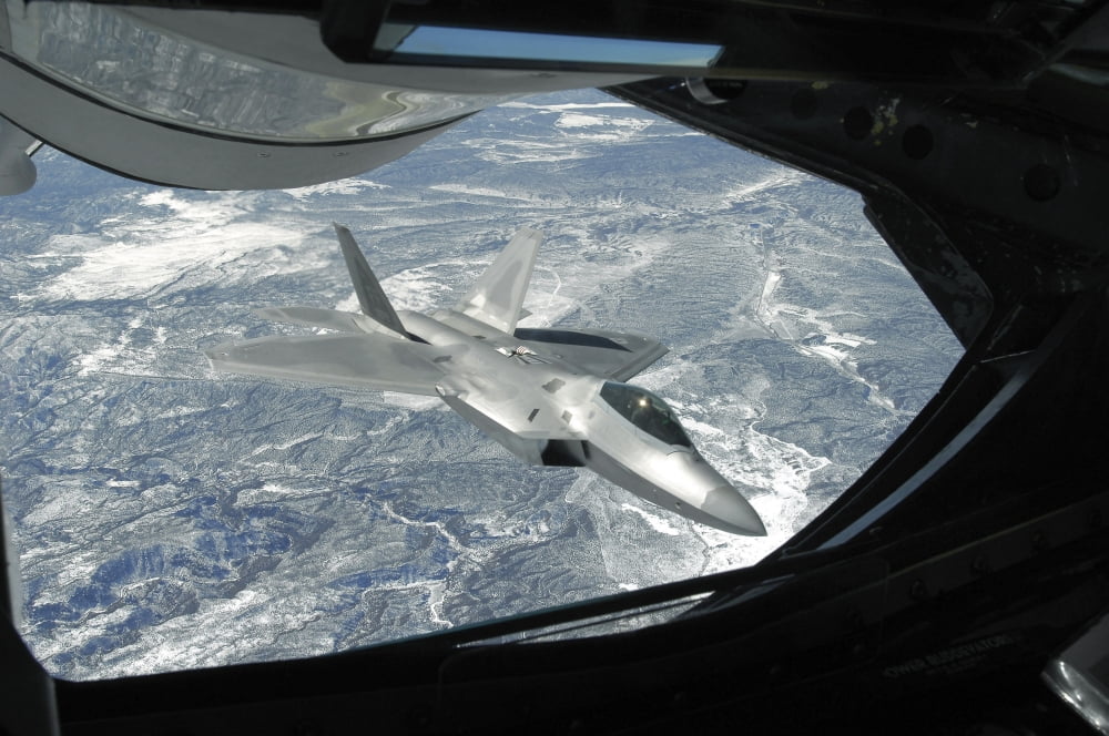 An F-22 Raptor banks away from a KC-135 Statotanker during a refueling operation Canvas Art - Stocktrek Images (35 x 23)
