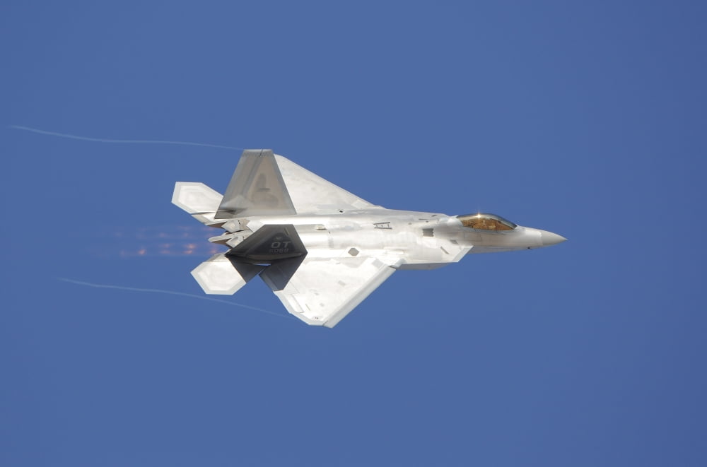An F-22 Raptor in flight over Nellis Air Force Base Nevada Canvas Art - Remo GuidiStocktrek Images (17 x 12)
