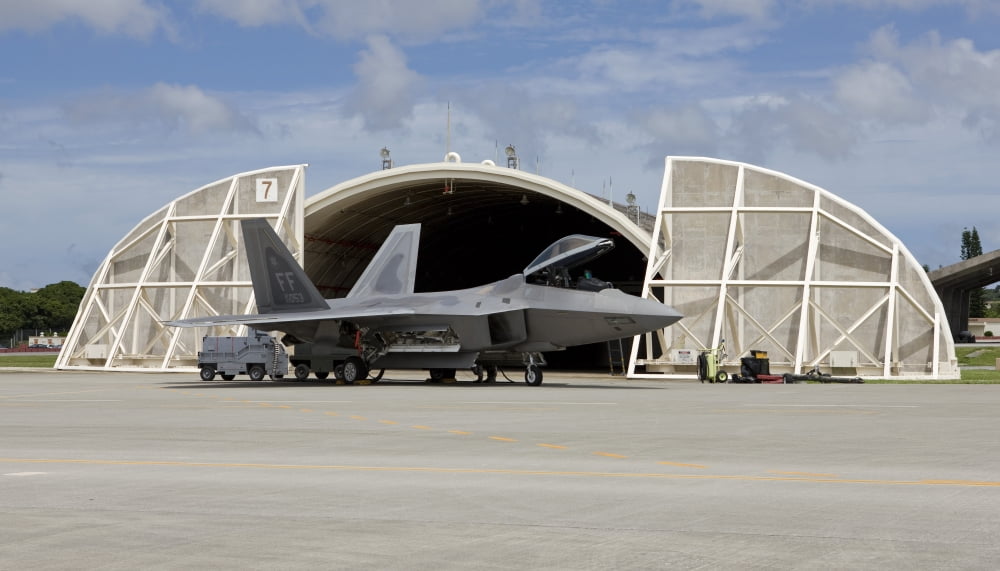 An F-22 Raptor parked in front of a hardened aircraft shelter at Kadena Air Base Canvas Art - HIGH-G ProductionsStocktrek Images (19 x 11)