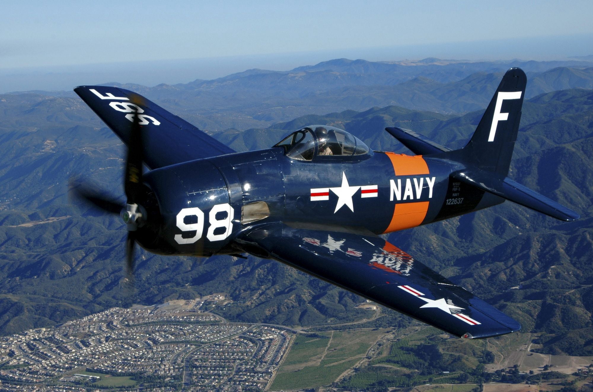 An F8F Bearcat flying over Chino California Canvas Art - Phil WallickStocktrek Images (34 x 23)