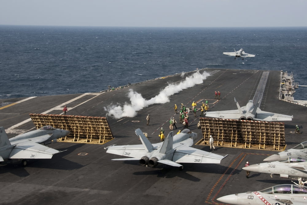 An FA-18 Hornet launches from the aircraft carrier USS George Washington Canvas Art - Stocktrek Images (35 x 23)