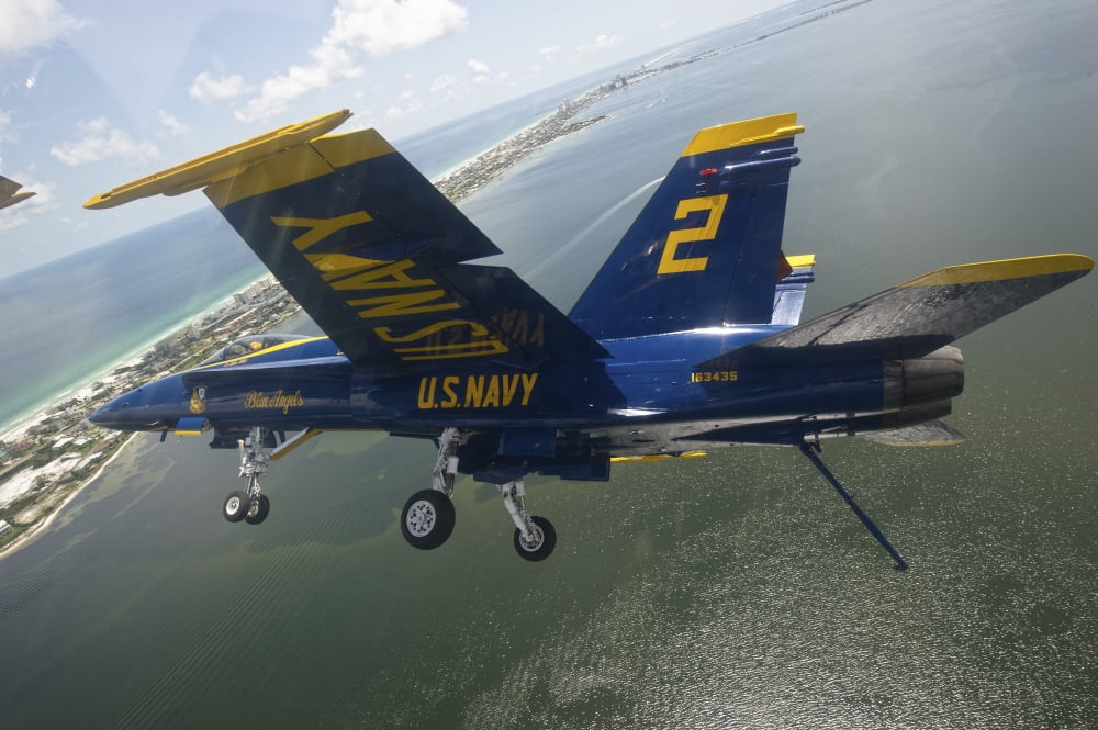 An FA-18 Hornet of the Blue Angels in flight over Pensacola Beach Florida Canvas Art - Stocktrek Images (35 x 23)