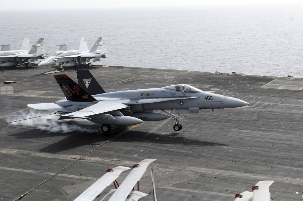 An FA-18A Hornet lands aboard the aircraft carrier USS George HW Bush Canvas Art - Stocktrek Images (35 x 23)