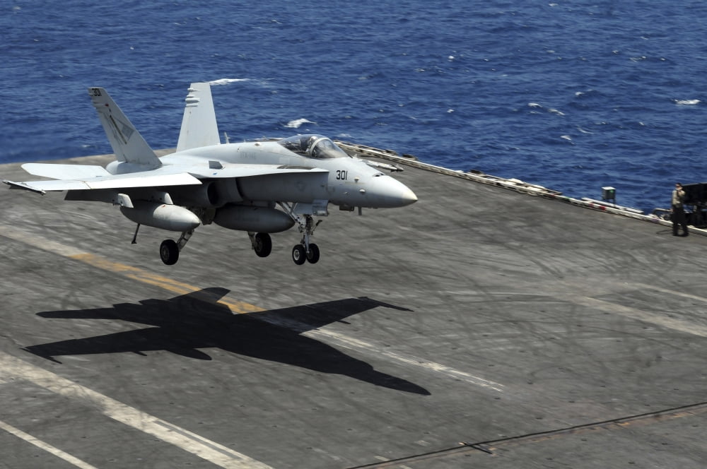 An FA-18C Hornet lands aboard the aircraft carrier USS Ronald Reagan Canvas Art - Stocktrek Images (35 x 23)