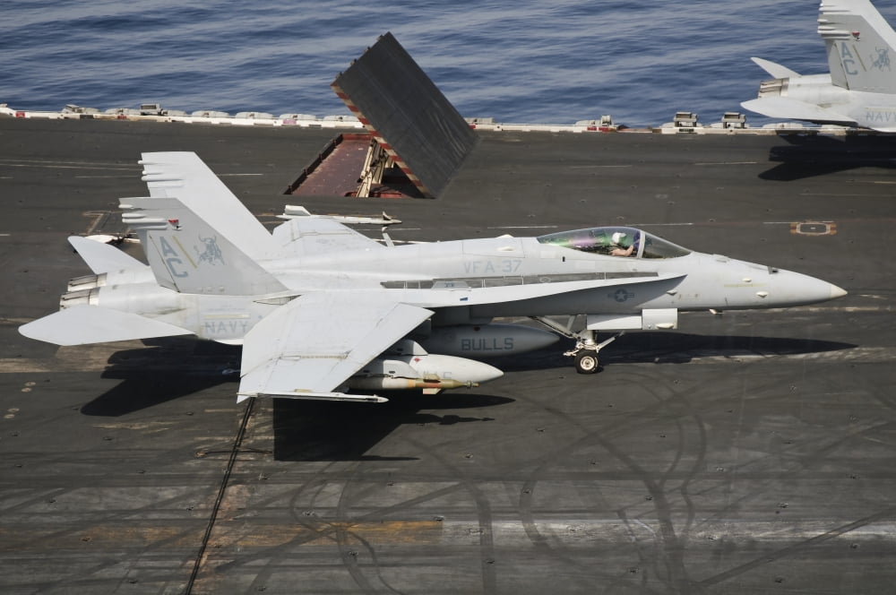 An FA-18C Hornet sits ready on the flight deck of USS Harry S Truman Canvas Art - Giovanni CollaStocktrek Images (35 x 23)