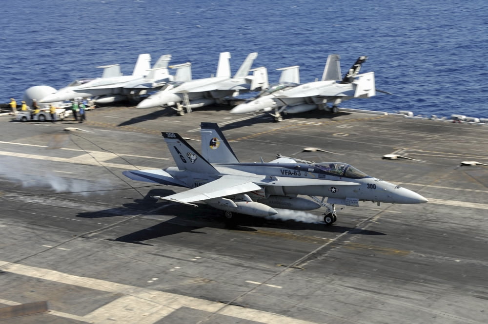 An FA-18E Super Hornet lands aboard the aircraft carrier USS Dwight D Eisenhower Canvas Art - Stocktrek Images (35 x 23)