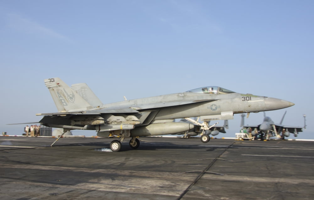 An FA-18E Super Hornet makes an arrested landing aboard an aircraft carrier Canvas Art - Giovanni CollaStocktrek Images (18 x 12)
