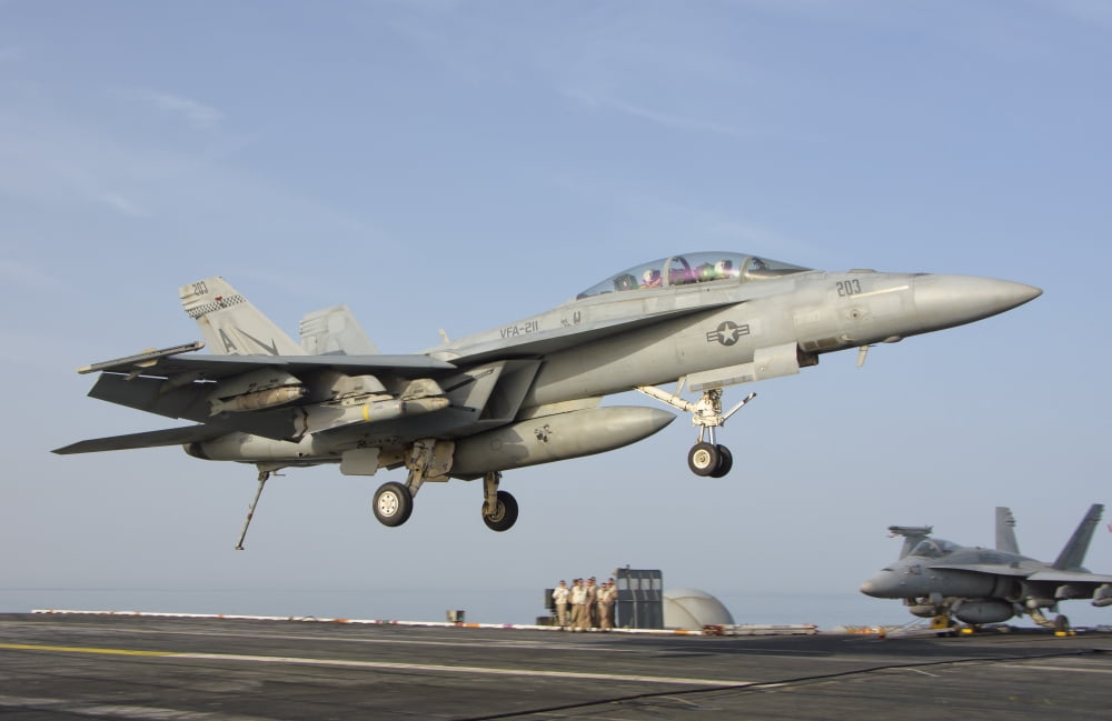 An FA-18E Super Hornet makes an arrested landing aboard an aircraft carrier Canvas Art - Giovanni CollaStocktrek Images (35 x 23)
