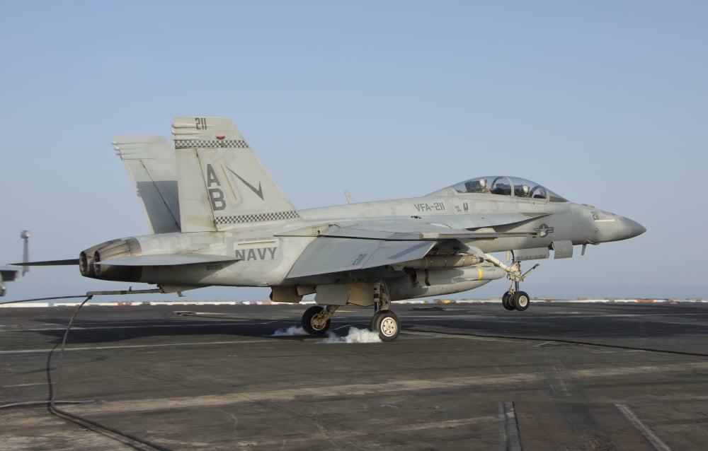 An FA-18E Super Hornet makes an arrested landing aboard an aircraft carrier Canvas Art - Giovanni CollaStocktrek Images (35 x 23)