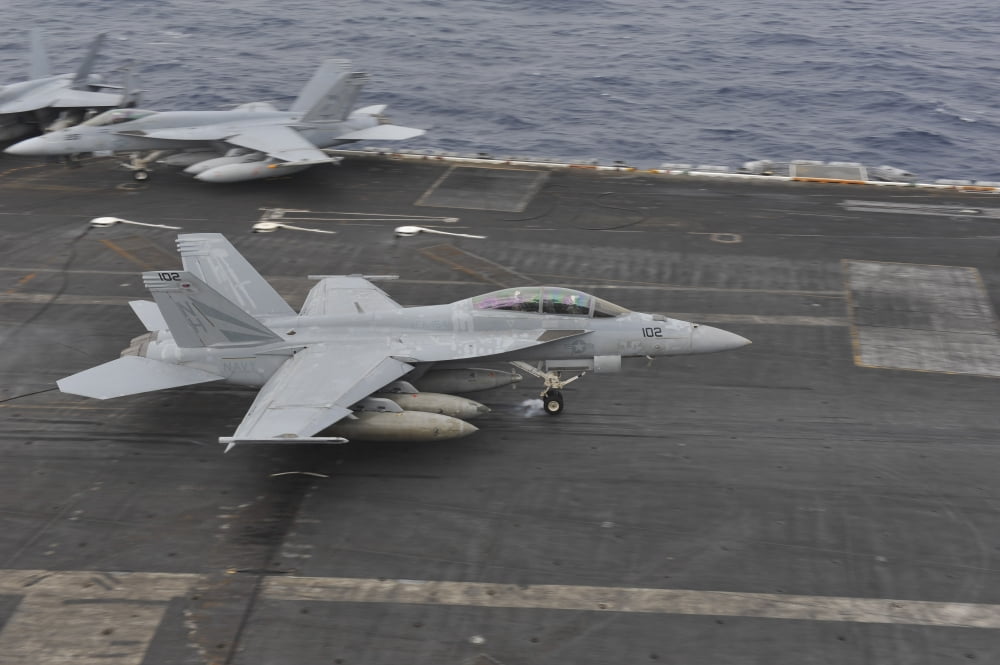 An FA-18F Super Hornet lands on the flight deck aboard USS Nimitz Canvas Art - Stocktrek Images (34 x 23)